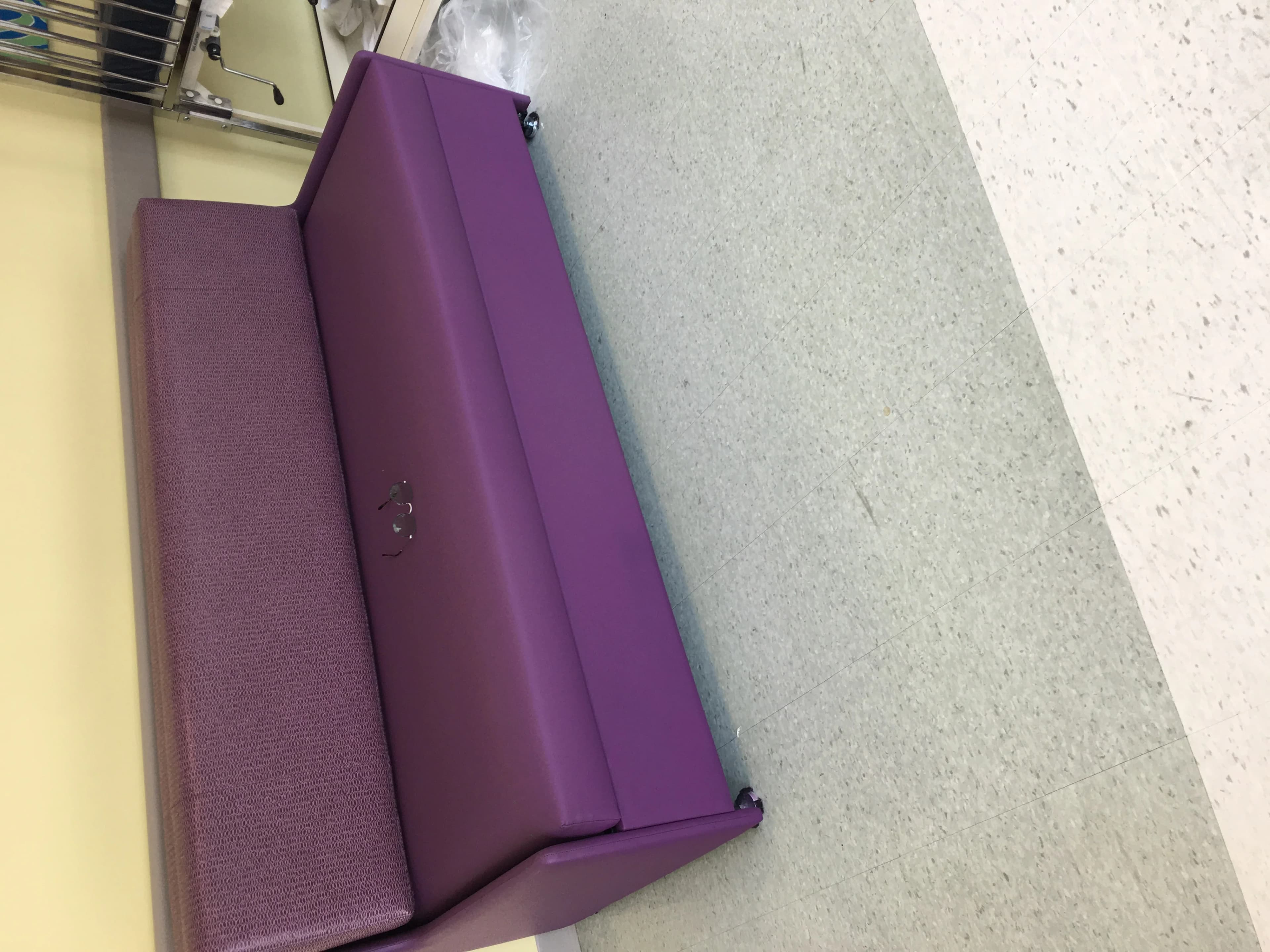 Repaired purple medical sleeper sofa showing healthcare-grade upholstery