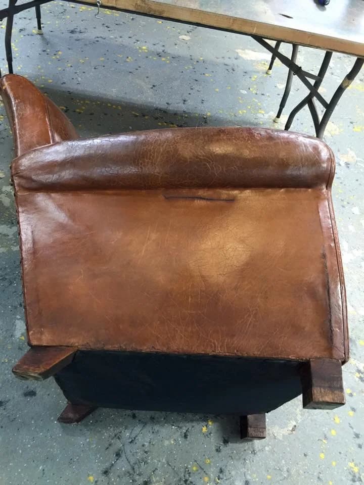 Vintage leather club chair before restoration